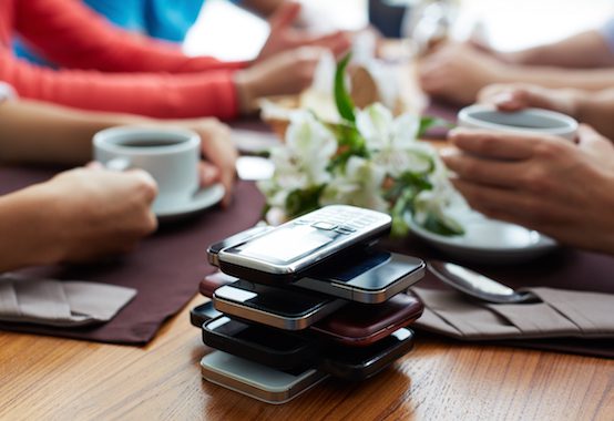 stack cellphones coffee friends