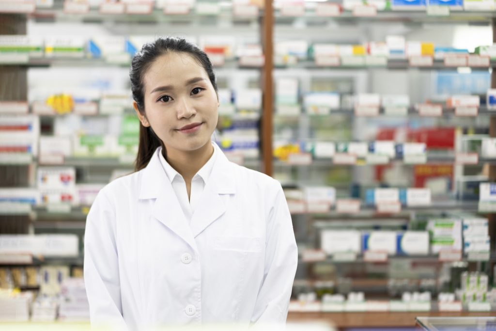 A young Asian woman works in a pharmacy