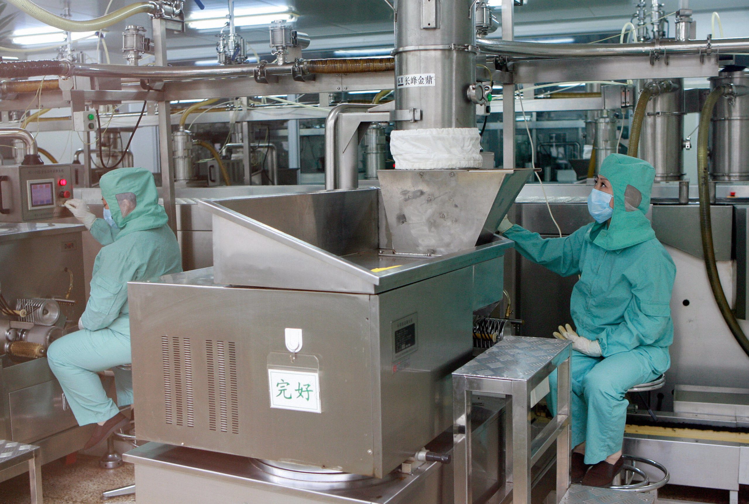 Chinese workers watch the production lin