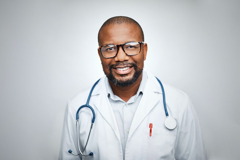 Doctor wearing eyeglasses on white background