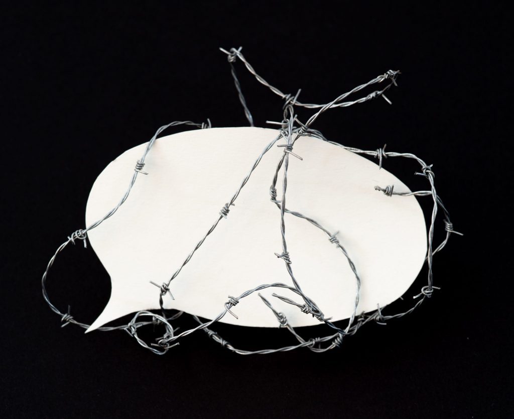 Protect the freedom of speech - barbed wire around a speech bubble