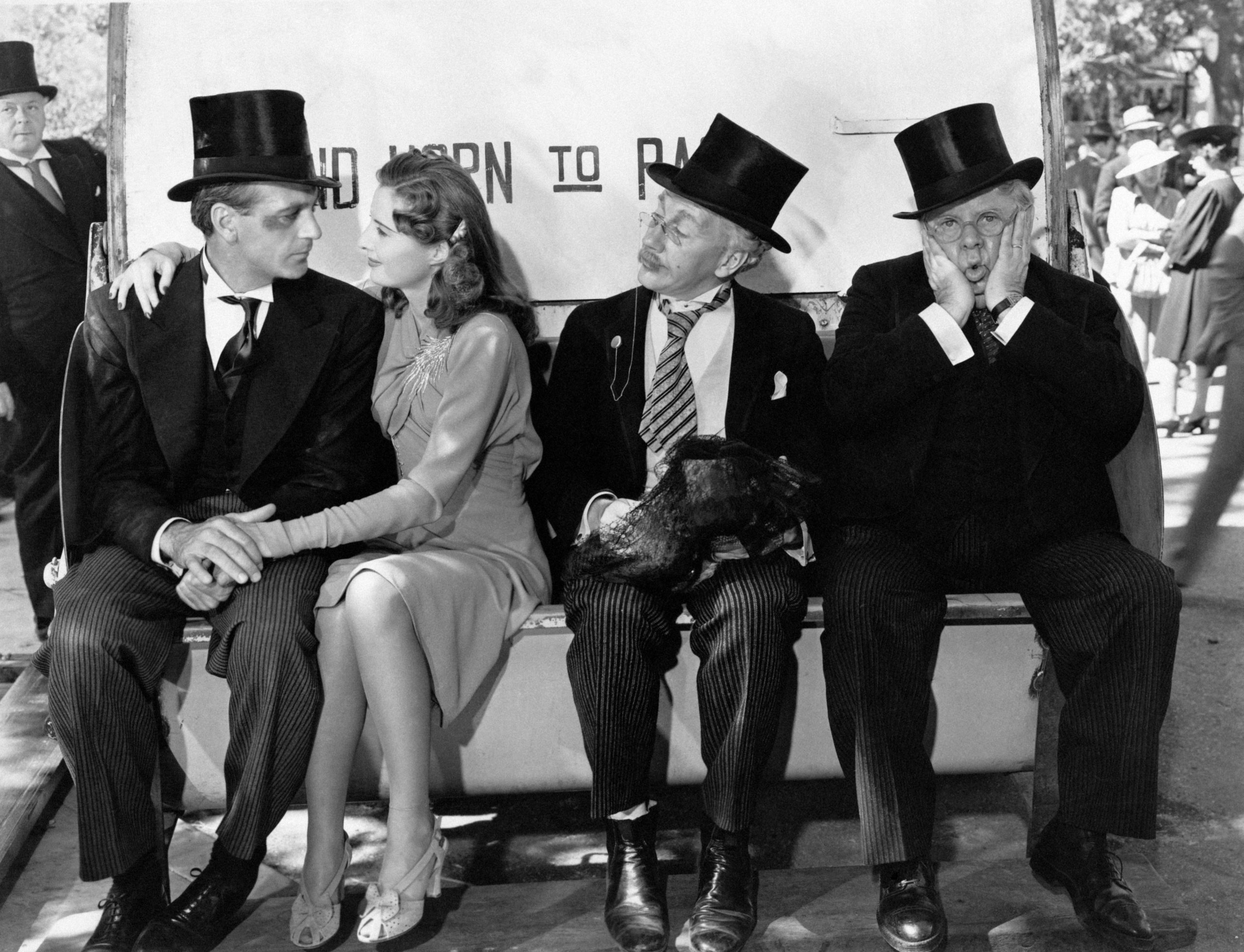 Barbara Stanwick on a bench with Gary Cooper, Henry Travers and S.Z Sakall