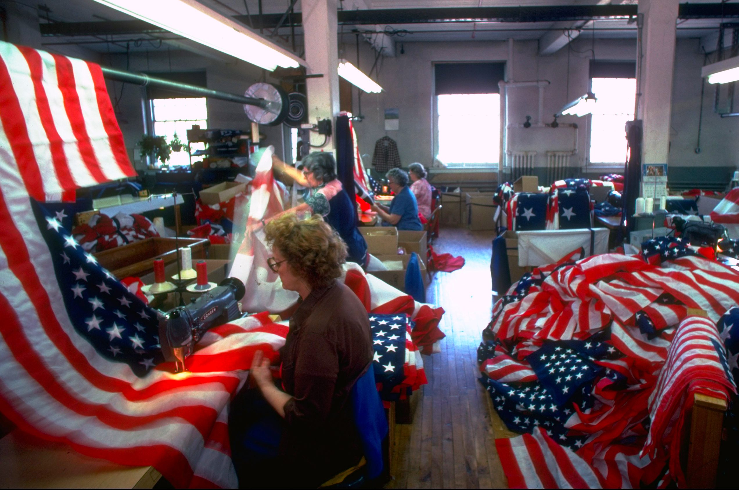 Women workers manning sewing machines at