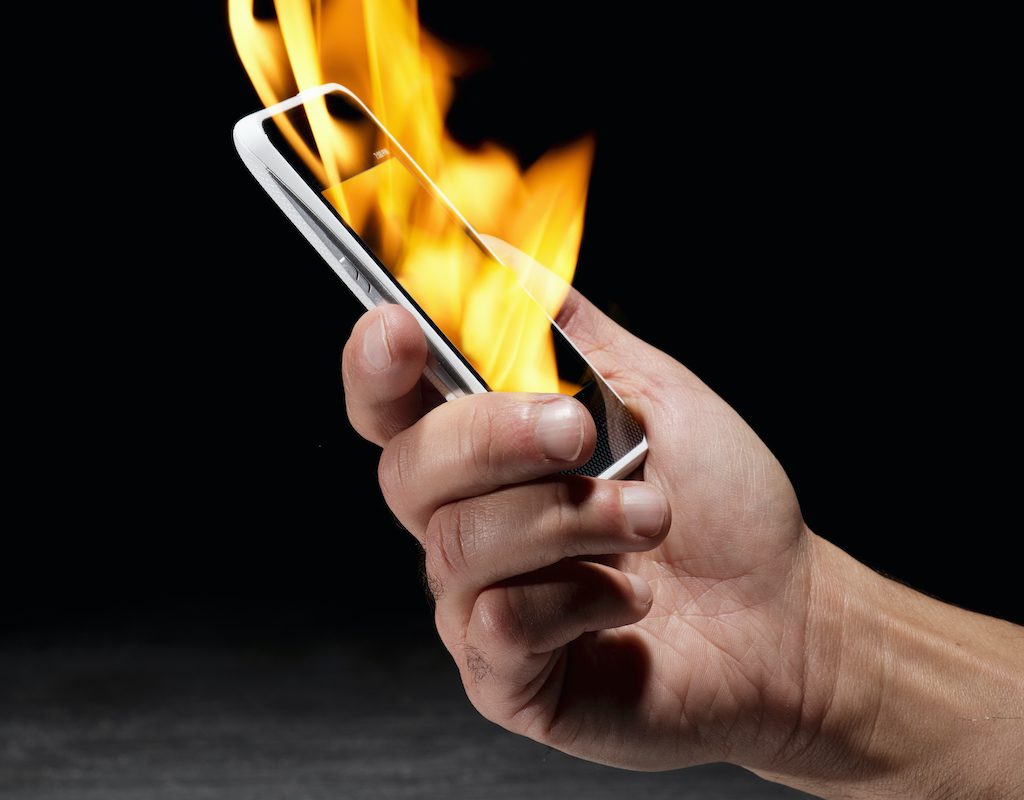 Holding smartphone on fire
