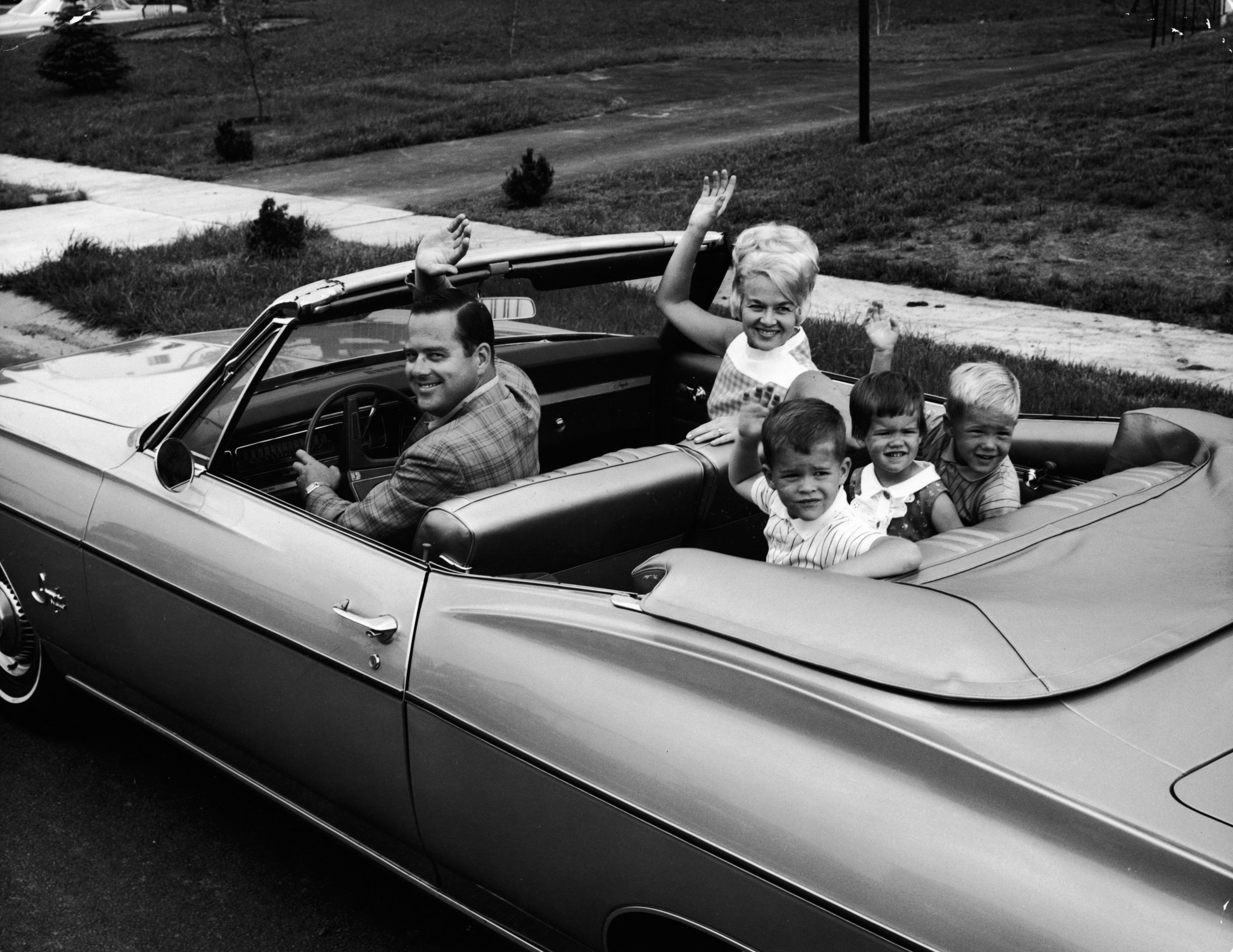 Family Waves From 1960s Convertible.
