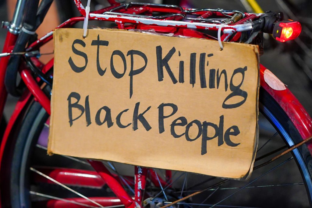 A 'Stop Killing Black People' placard seen on a bike during