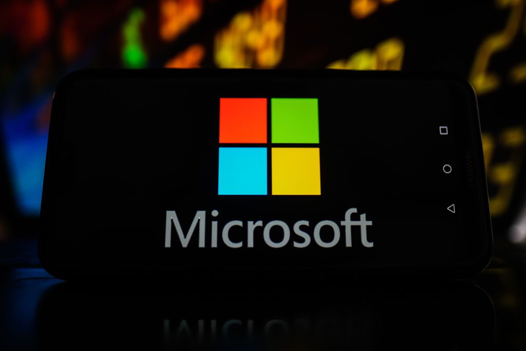 In this photo illustration a Microsoft logo seen displayed