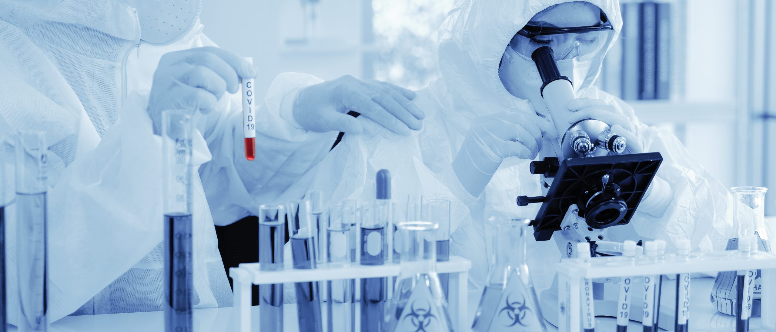 Scientist,In,Biohazard,Protection,Clothing,Analyzing,Covid,19,Sample,With