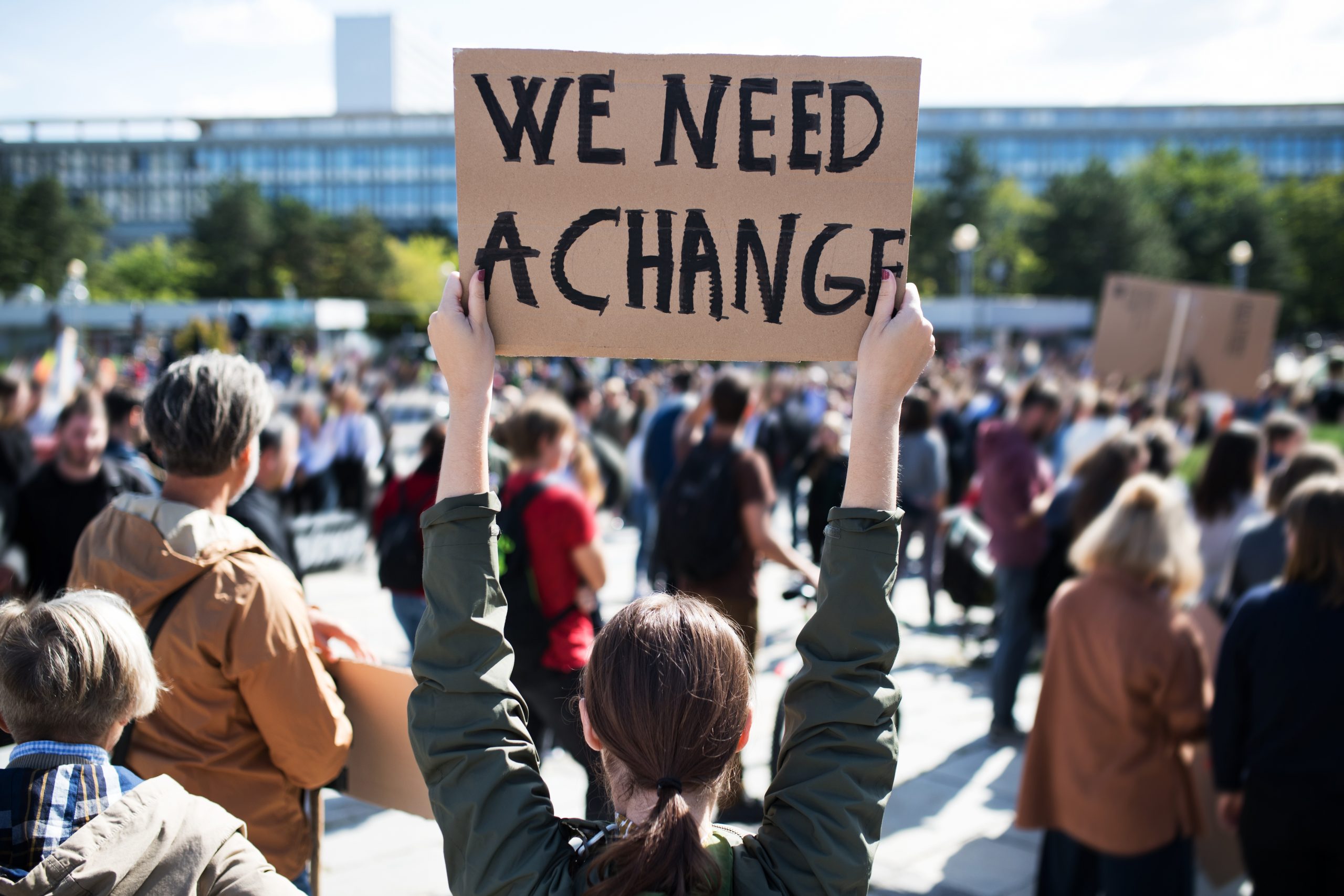 Rear,View,Of,People,With,Placards,And,Posters,On,Global