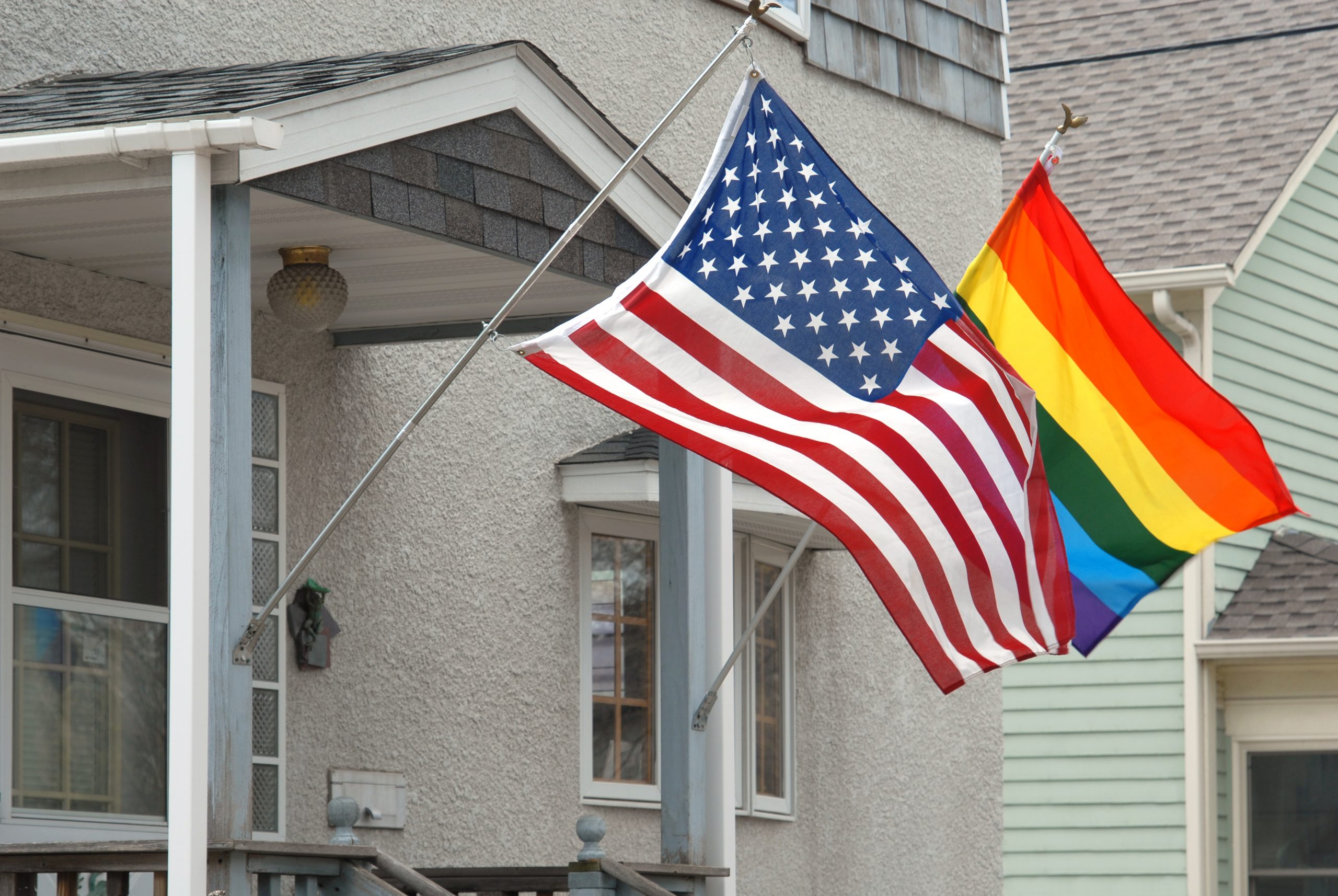 American,And,Rainbow,Flag,Blowing,In,The,Wind,On,A