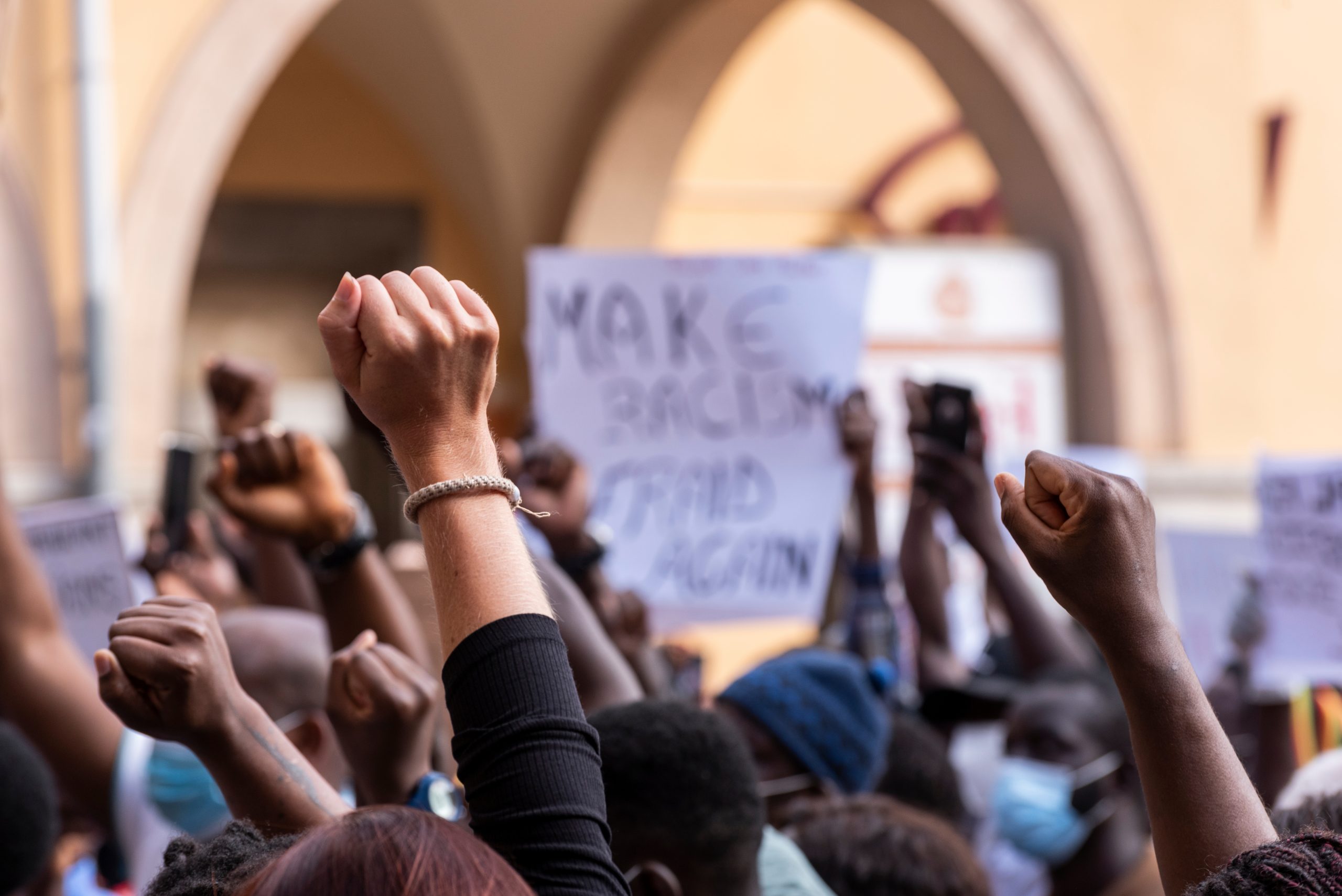 People,Raising,Fist,With,Unfocused,Background,In,A,Pacifist,Protest