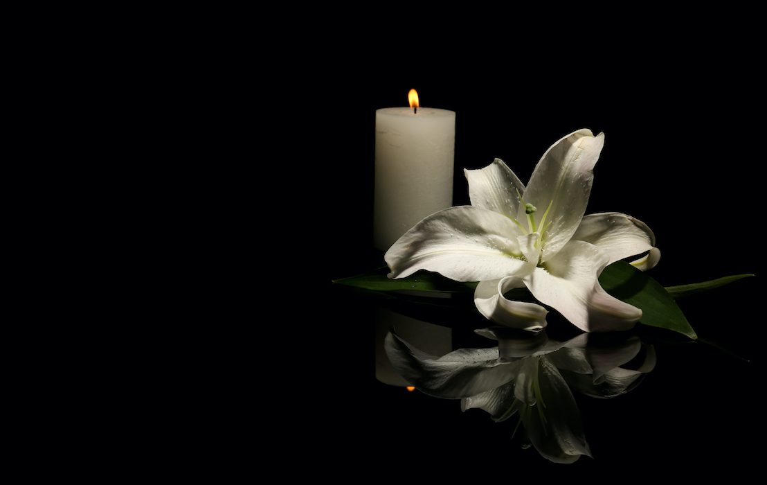 Beautiful,Lily,And,Burning,Candle,On,Dark,Background,With,Space
