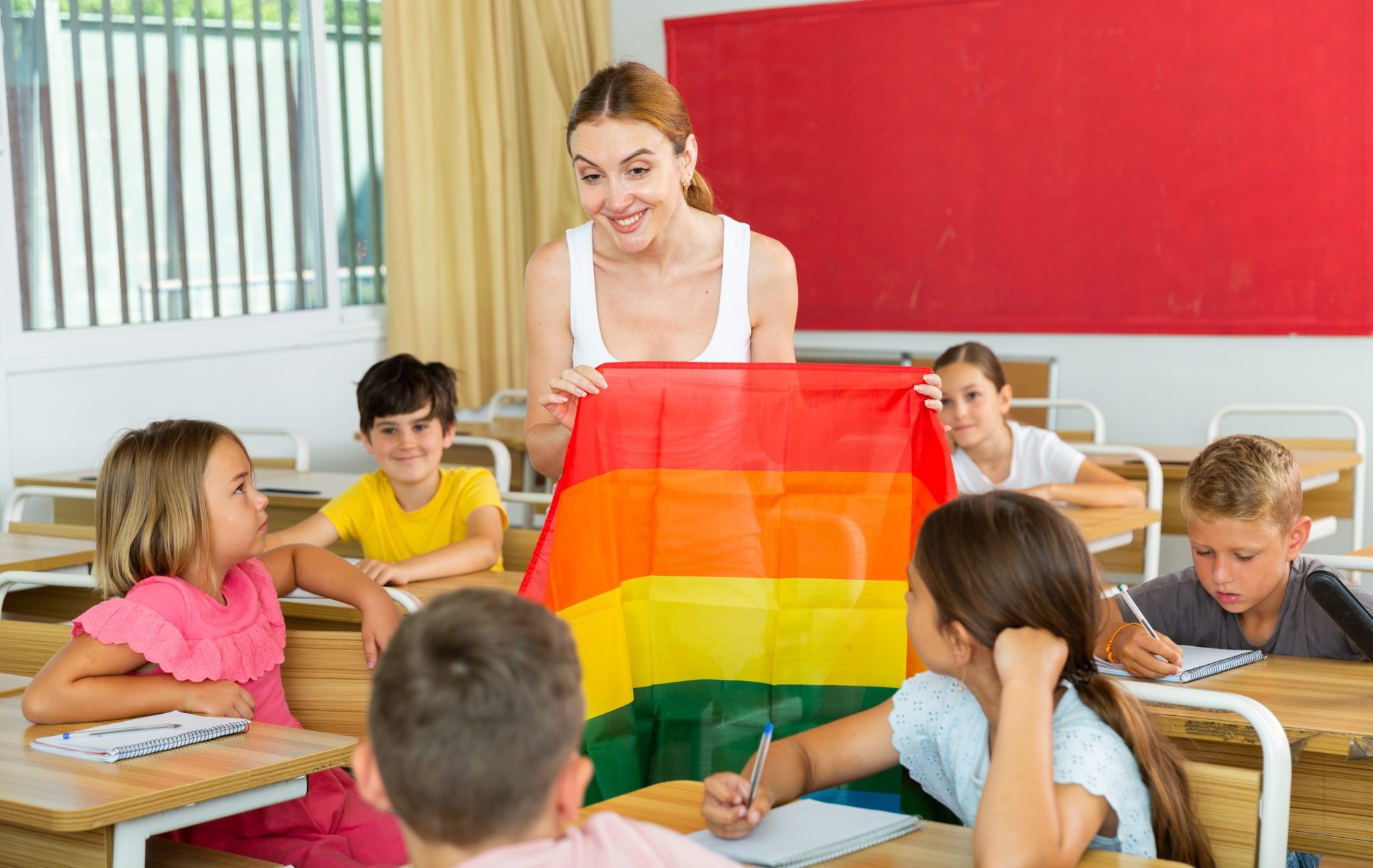 Schoolchildren,Sitting,In,Classroom,And,Listening,To,Female,Teacher.,She