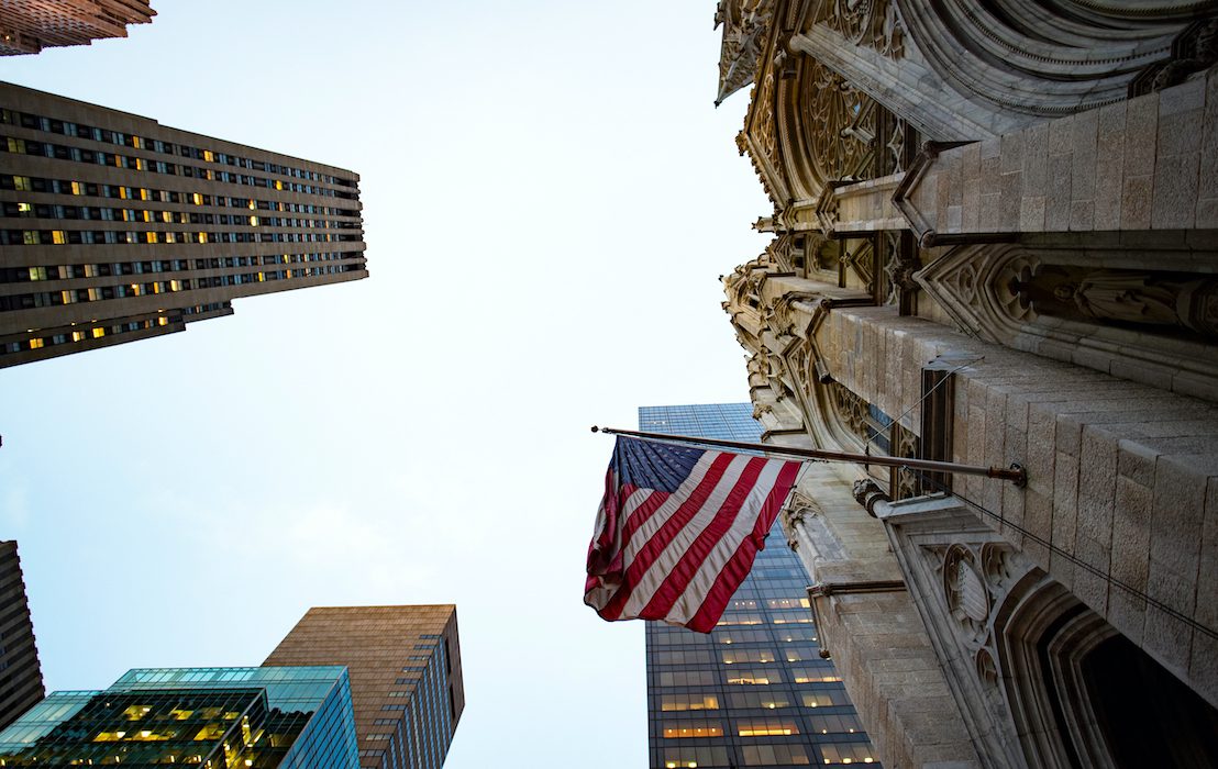 An,American,Flag,Is,Waving,On,A,Church,In,Manhattan.