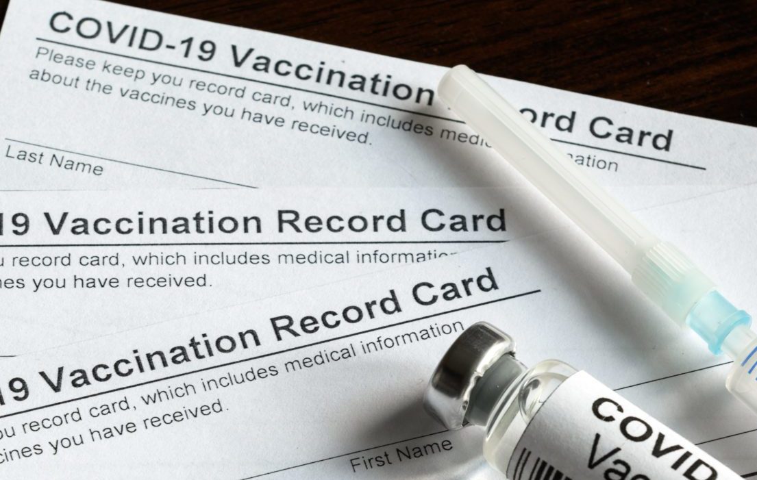 Covid-19,Vaccination,Record,Card,On,Desk,,Coronavirus,Immunization,Certificate,And