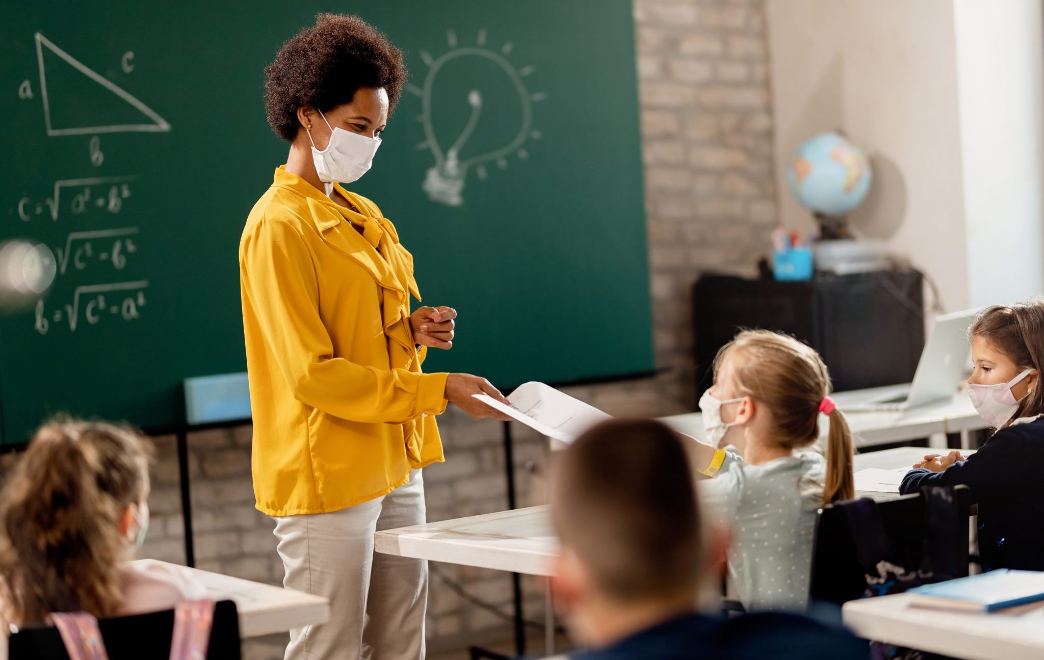 Happy,Black,Teacher,And,Her,Students,Wearing,Protective,Face,Mask
