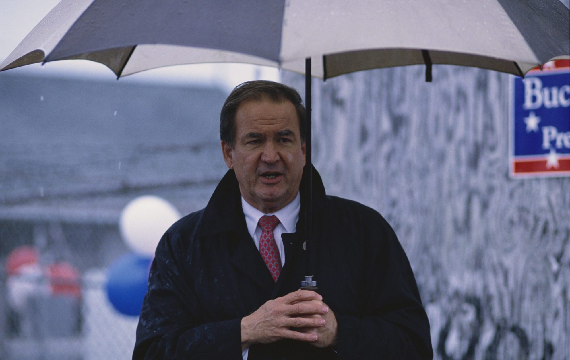 Pat Buchanan Holding Umbrella at a Rally