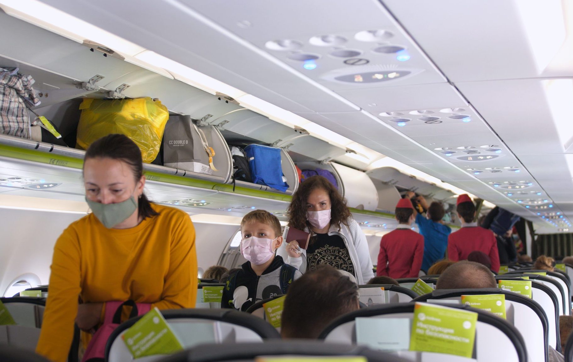 People,With,Masks,Get,On,Airplane.,Passengers,Wearing,Surgical,Mask