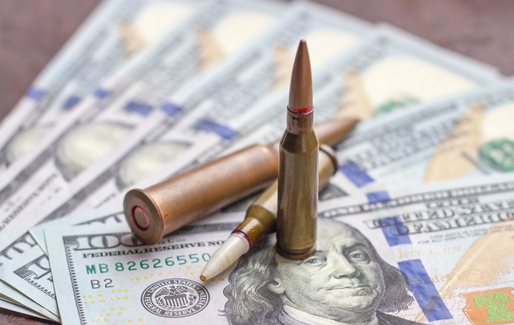Weapon,Bullets,On,American,Dollars,Background.,Military,Industry,,War,,Global