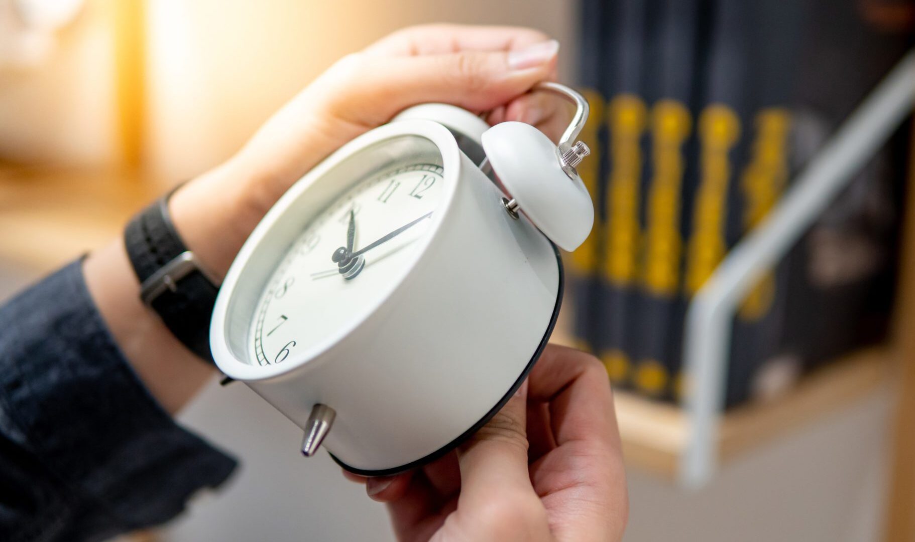 Male,Hand,Adjusting,Or,Changing,The,Time,On,White,Clock.