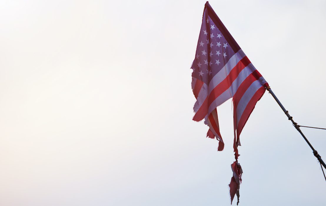 Torn,American,Flag,On,The,Sky,Background