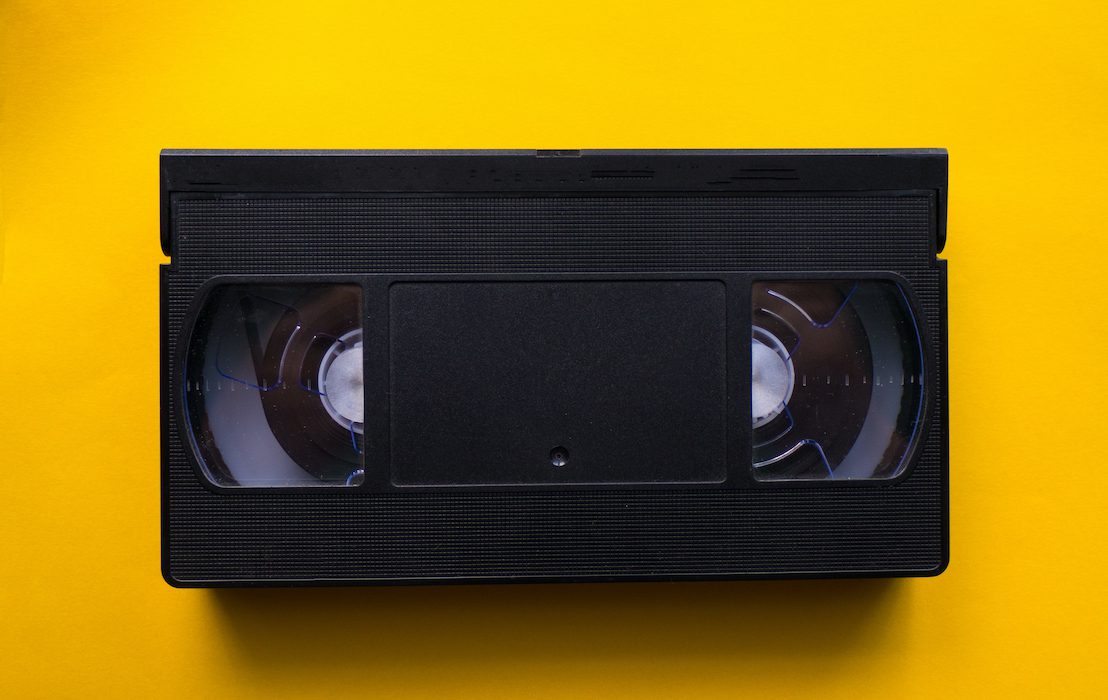 Video,Tape,On,A,Yellow,Background