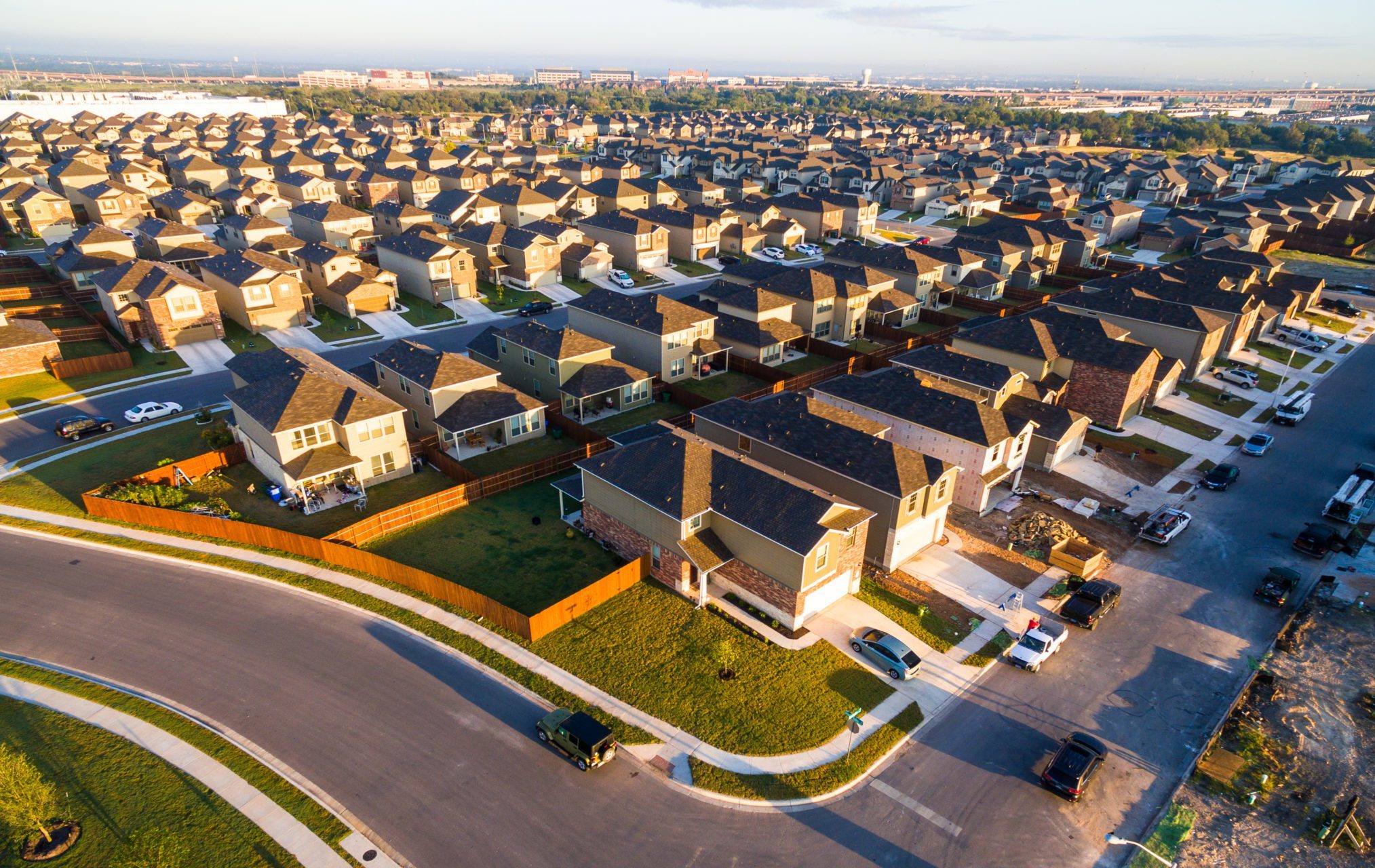 Golden,Sunrise,With,Row,After,Row,Of,Surburbia,Houses,Aerial