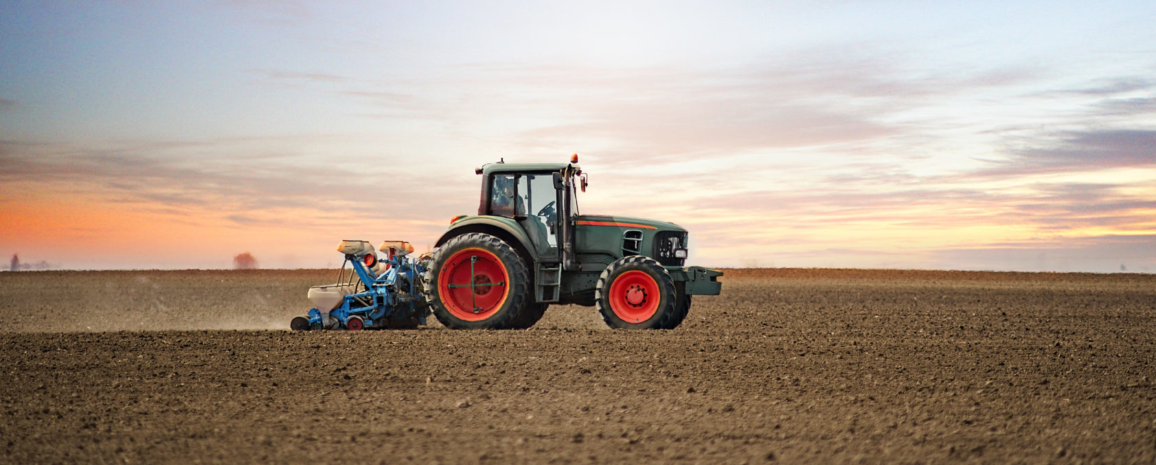 Panoramic,Landscape,View,Of,The,Tractor,On,The,Field,Sowing.