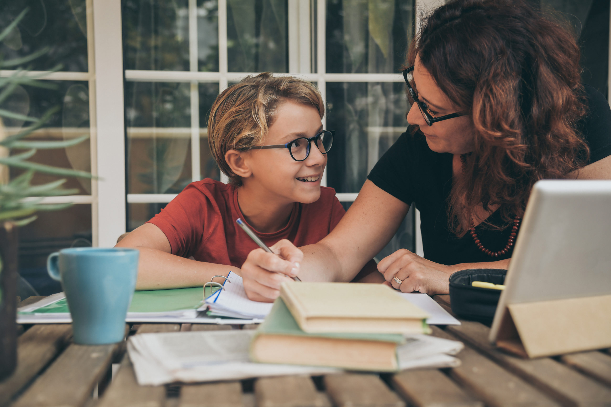 Young,Student,Doing,Homework,At,Home,With,School,Books,,Newspaper