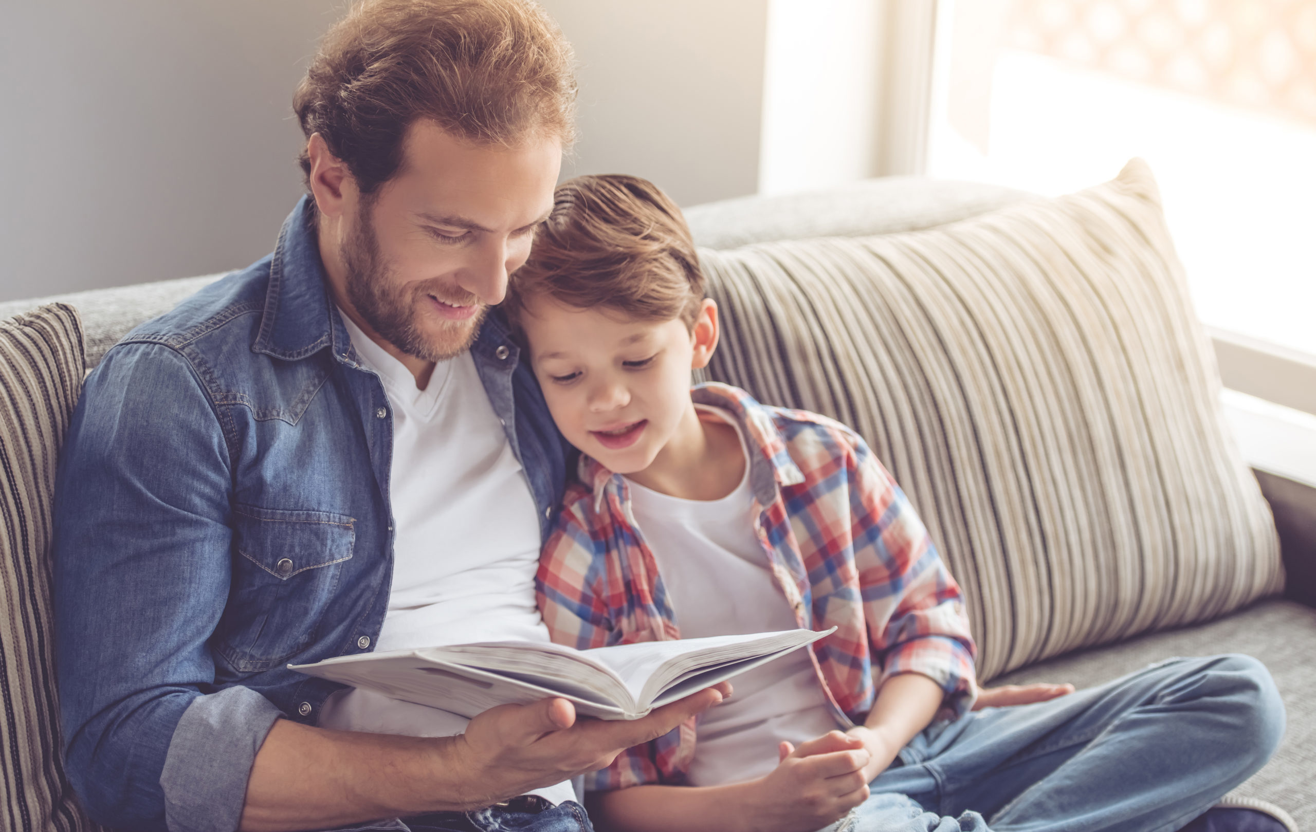 Father,And,Son,Are,Reading,A,Book,And,Smiling,While