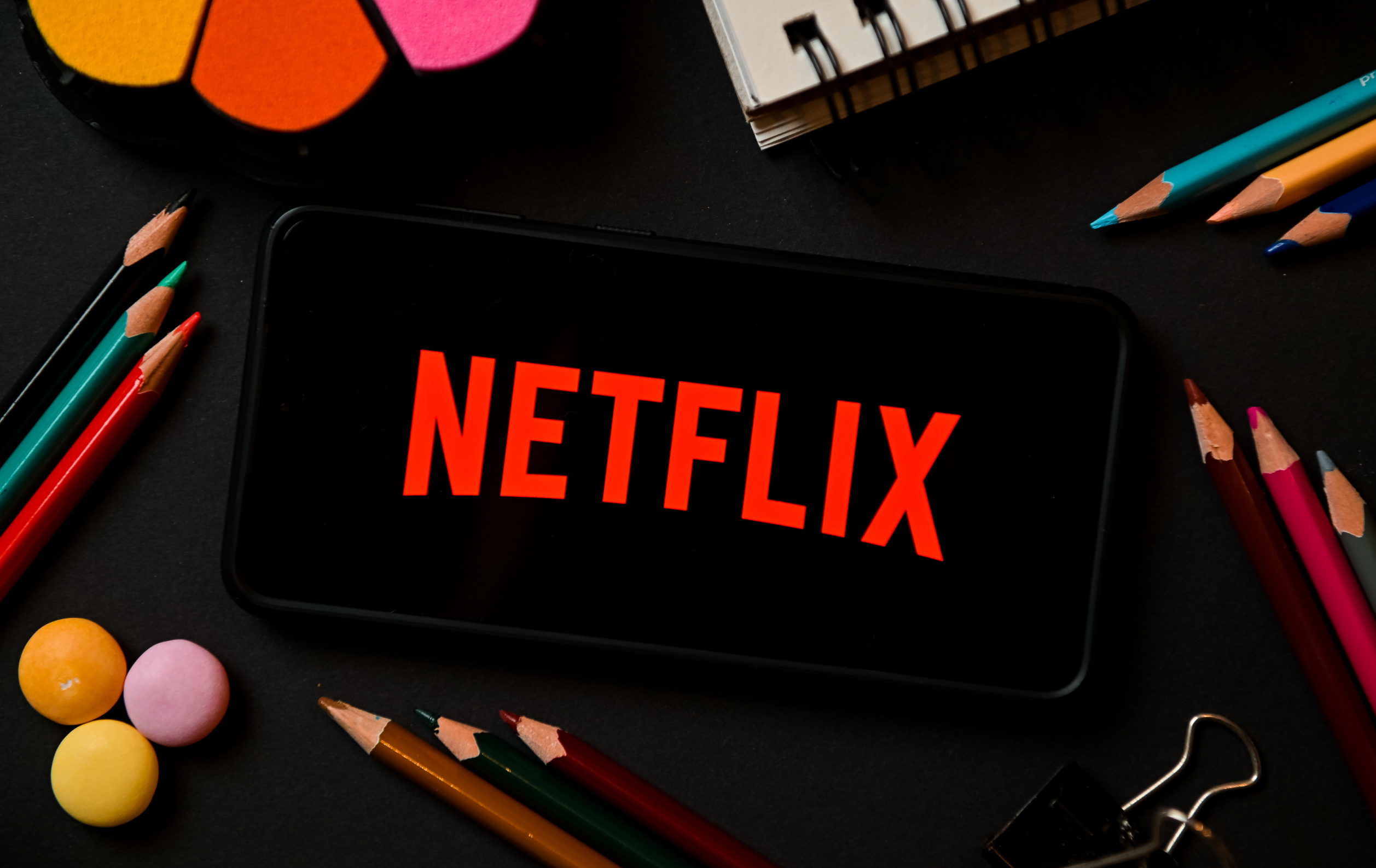 In this photo illustration a Netflix logo seen displayed on