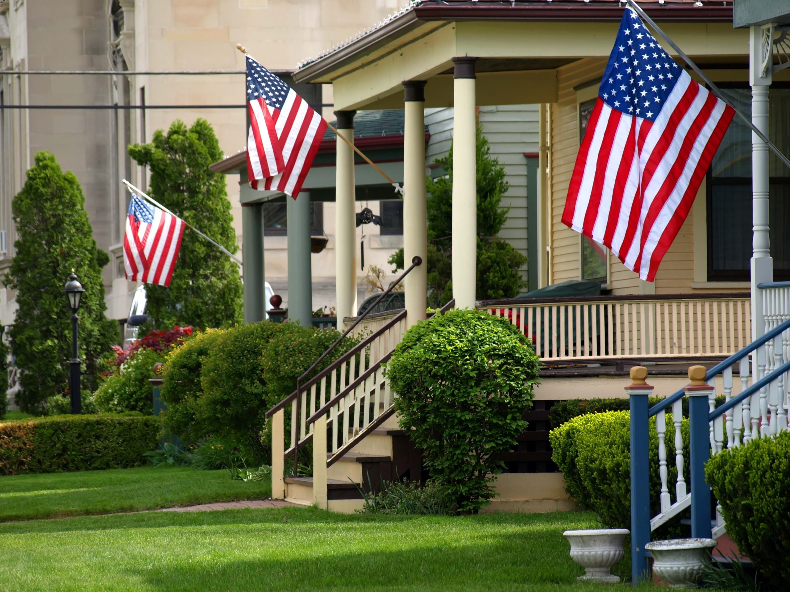 American,Flags,Flying,Proudly,On,Front,Porches,Of,A,Small