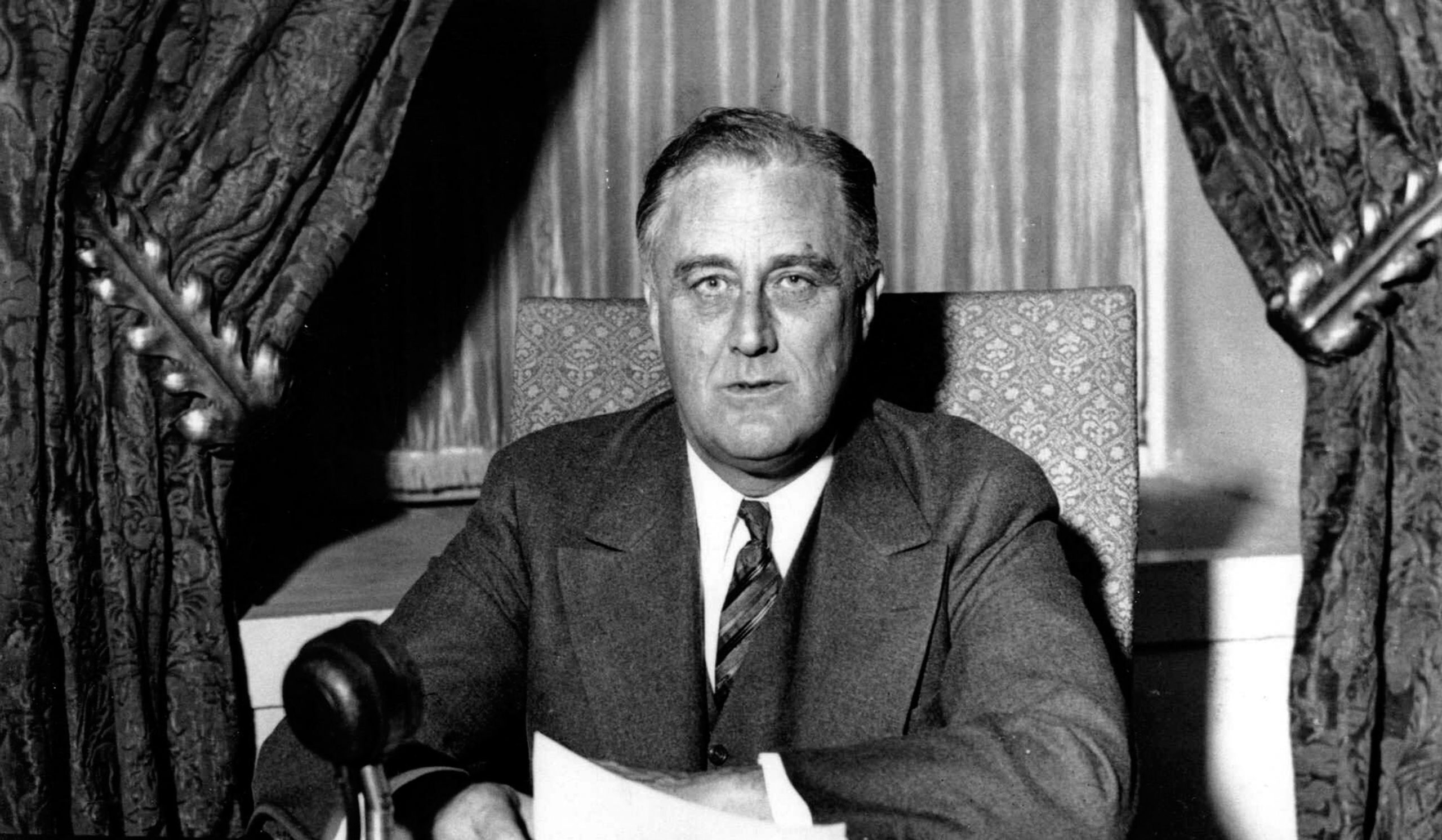 Franklin Delano Roosevelt (1882-1945), 32nd President of the United States of America 1933-1945, giving one of his 'fireside' broadcasts to the American nation during.