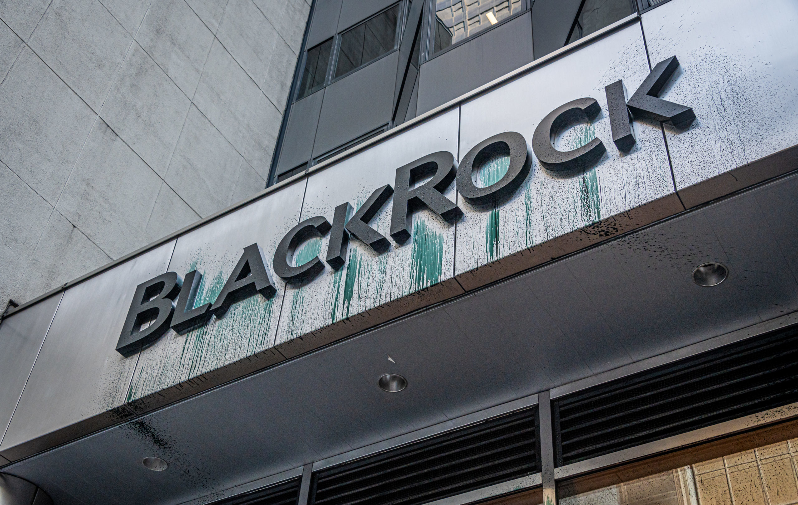 BlackRock logo seen sprayed with a "coal sludge" like