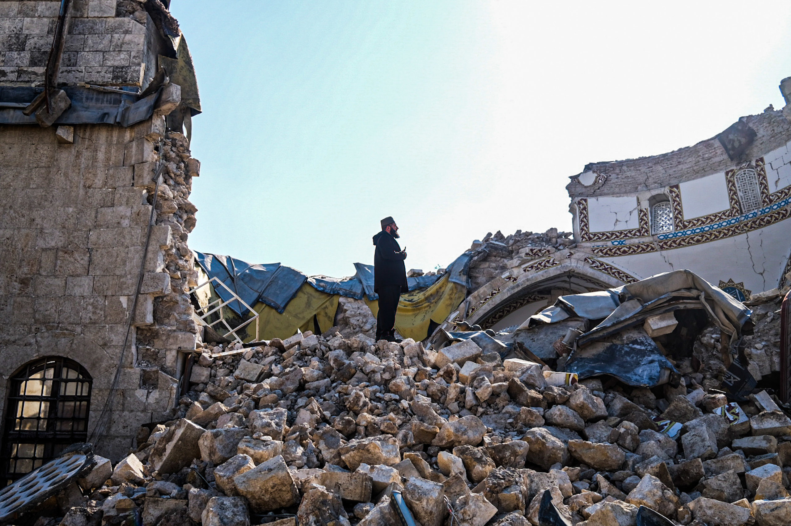 A man is seen on the rubble of the destroyed Habib-i Neccar