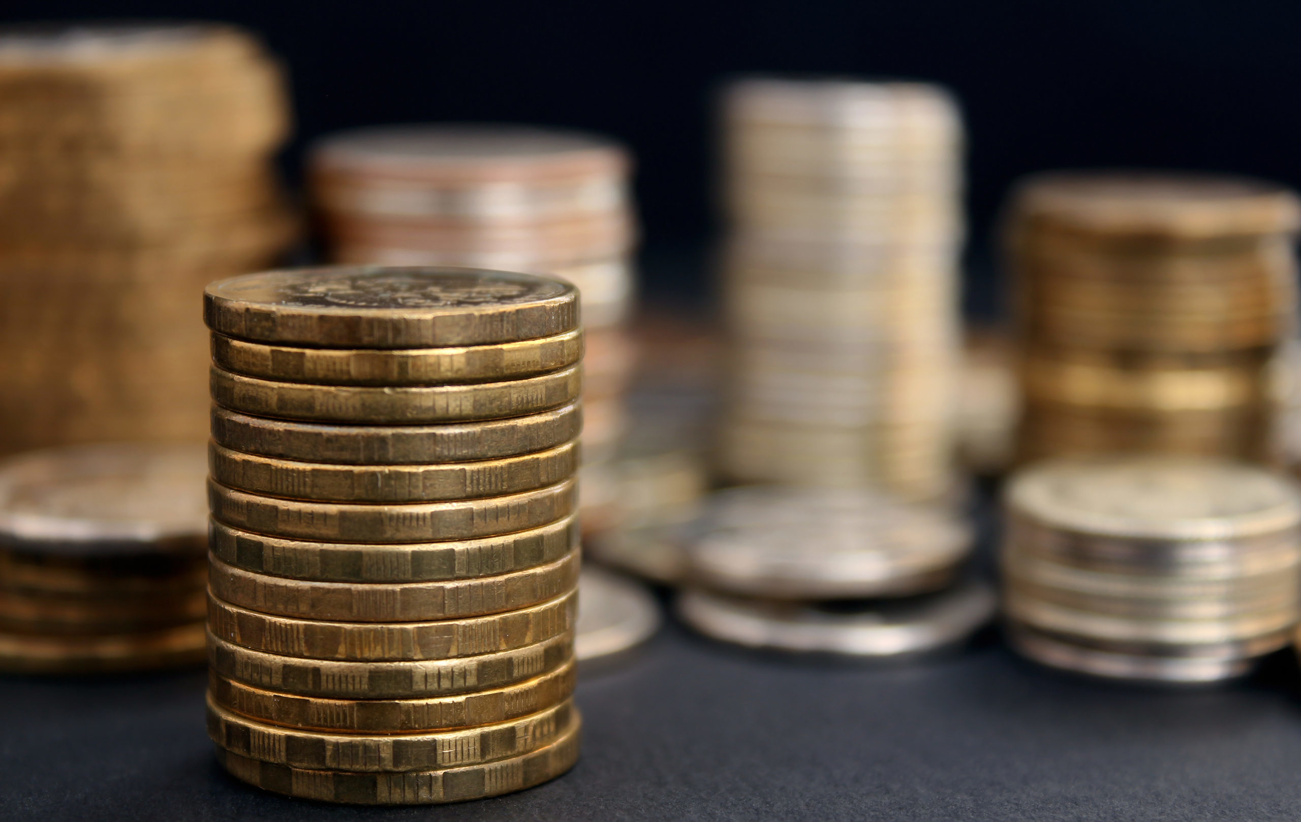 Stacks,Of,Coins,Close,Up,On,Black,Background