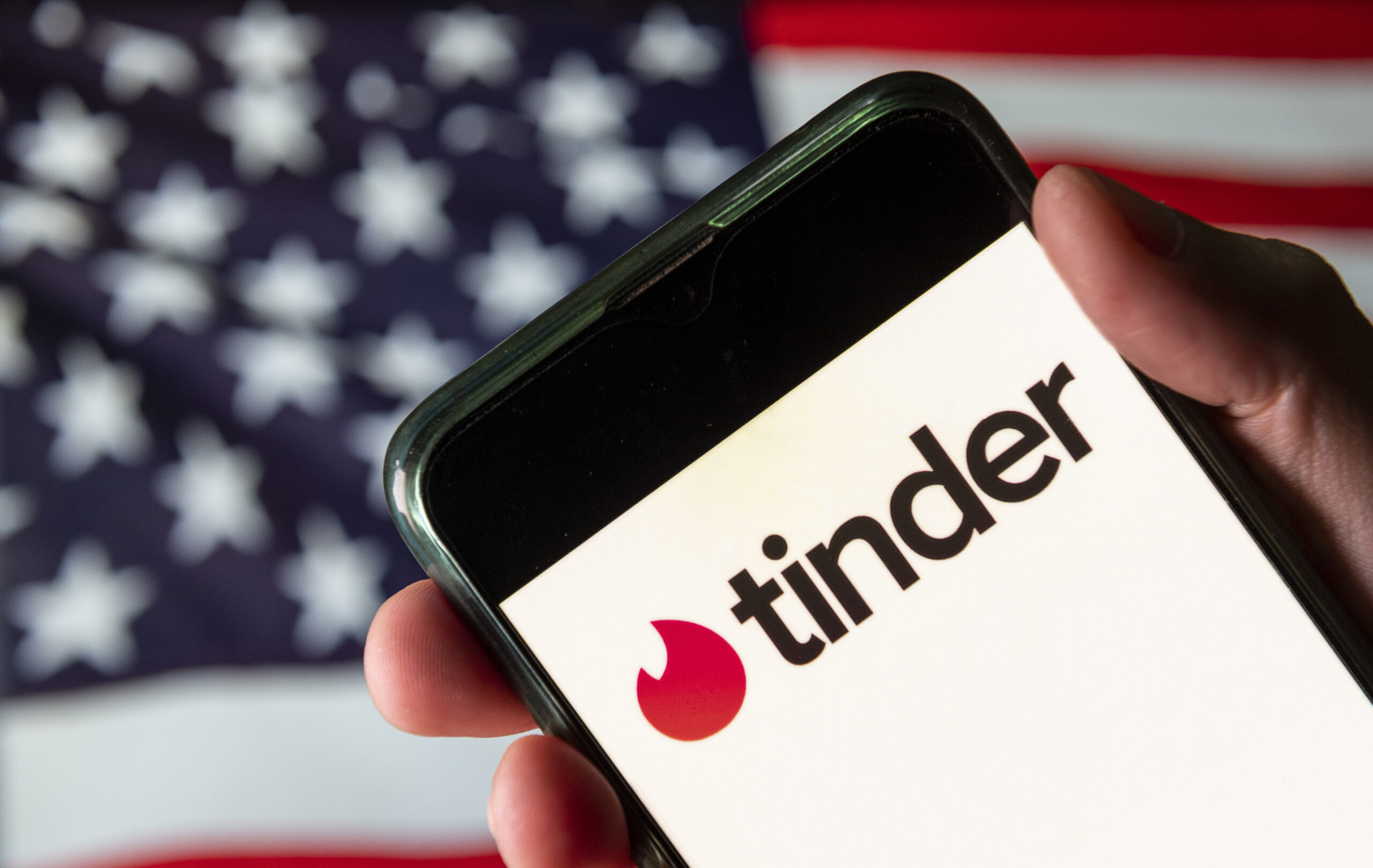 In this photo illustration the mobile dating app Tinder logo