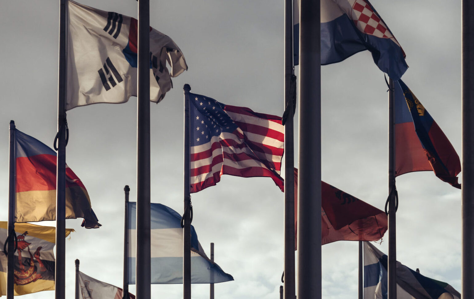 Flags of different nations on high flagpoles