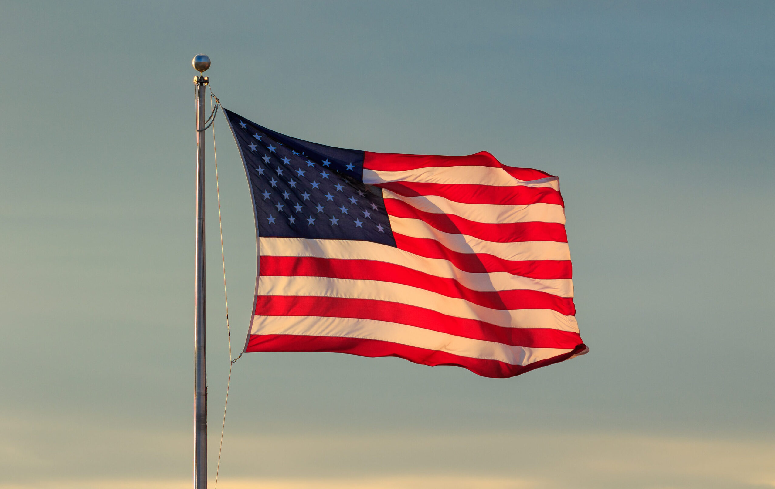 U.s.,Flag,And,Sky,At,Sunset