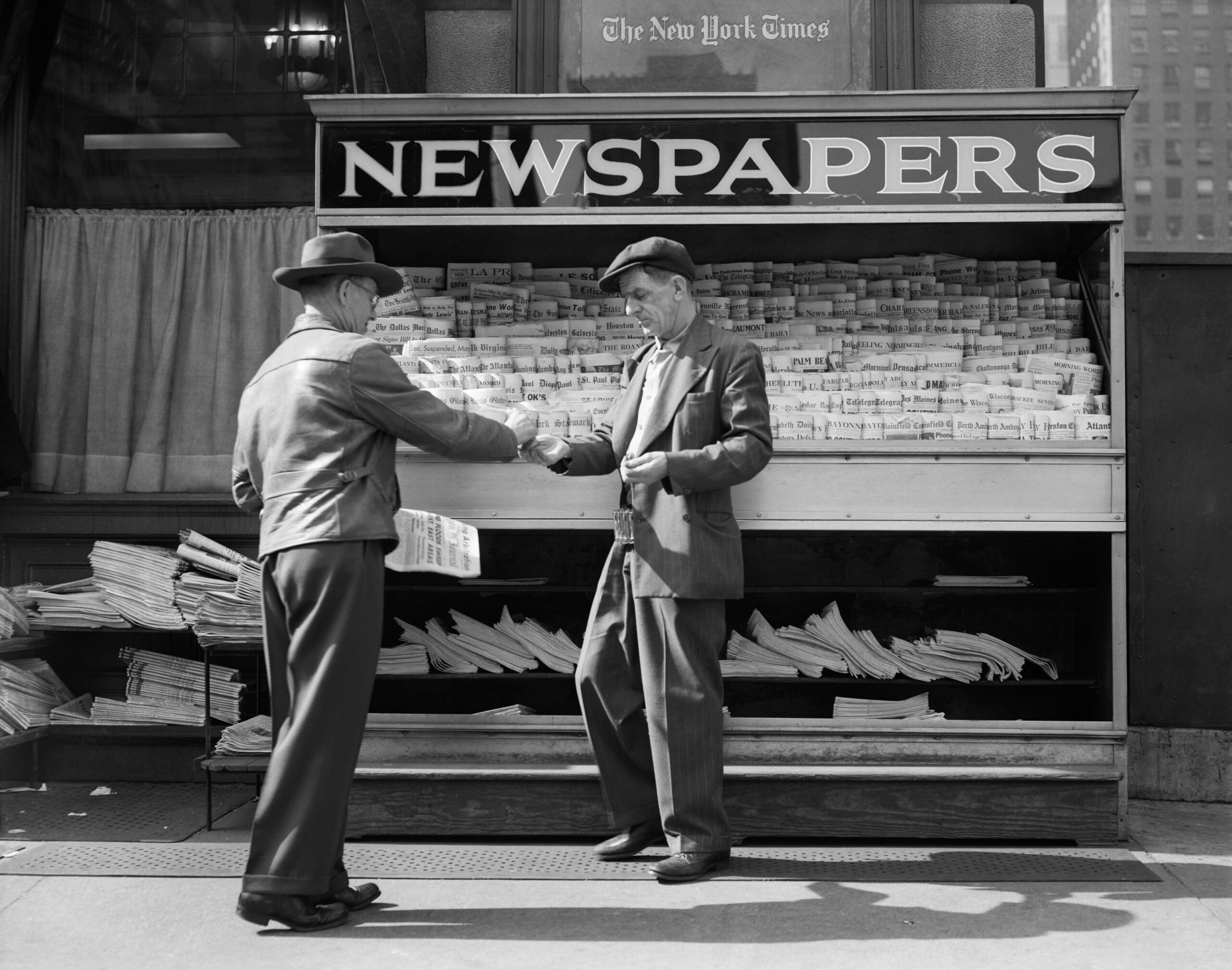 1940s MAN BUYING NEWSPAPER...