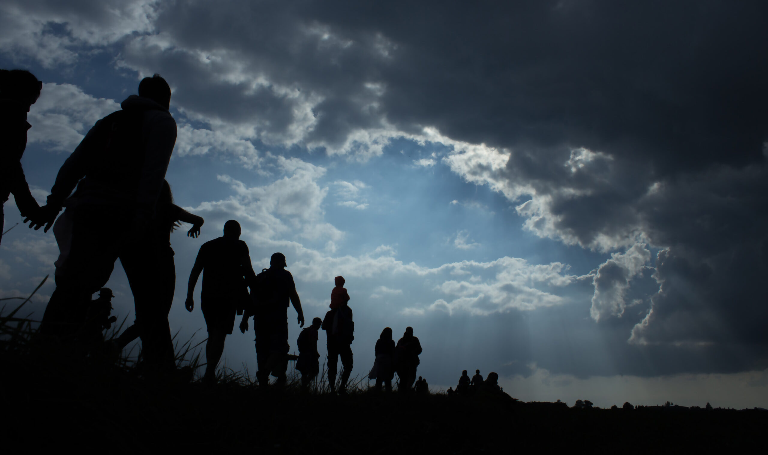 Sun,Rays,Illuminate,People.,Immigration,Of,People.,Blue,Sky,With