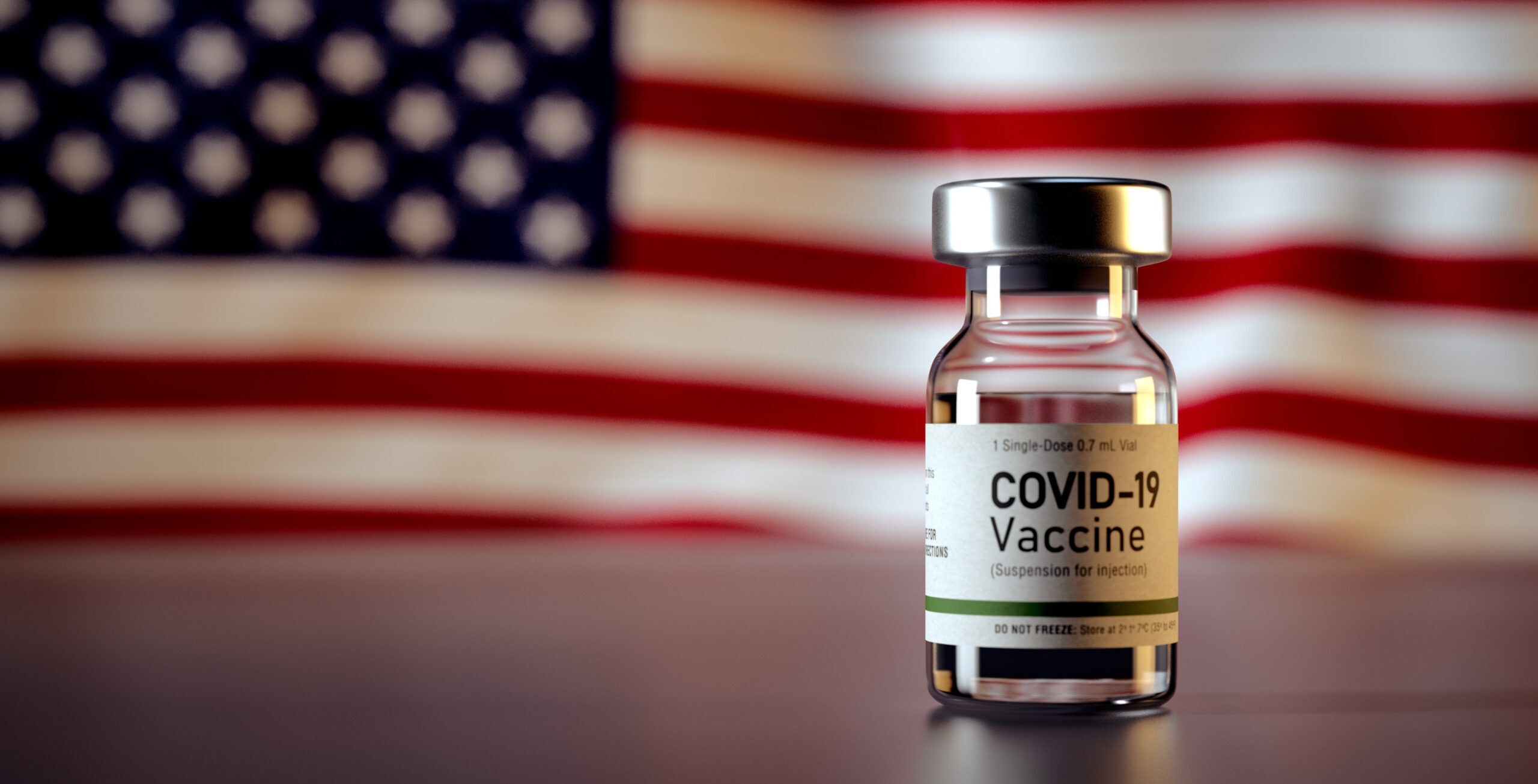 Covid,Vaccine,Bottle,With,The,American,Flag,In,The,Background