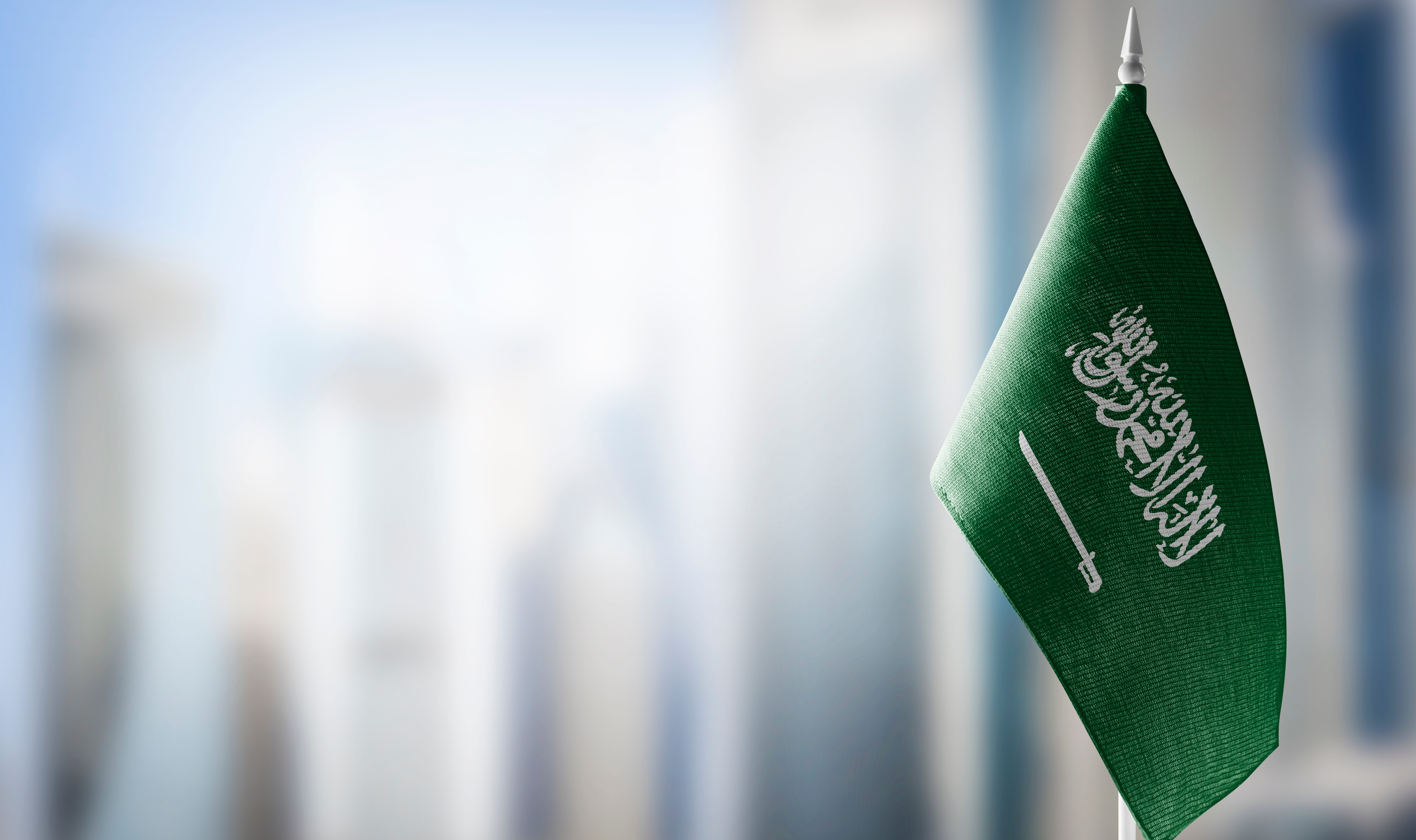 A,Small,Flag,Of,Saudi,Arabia,On,The,Background,Of