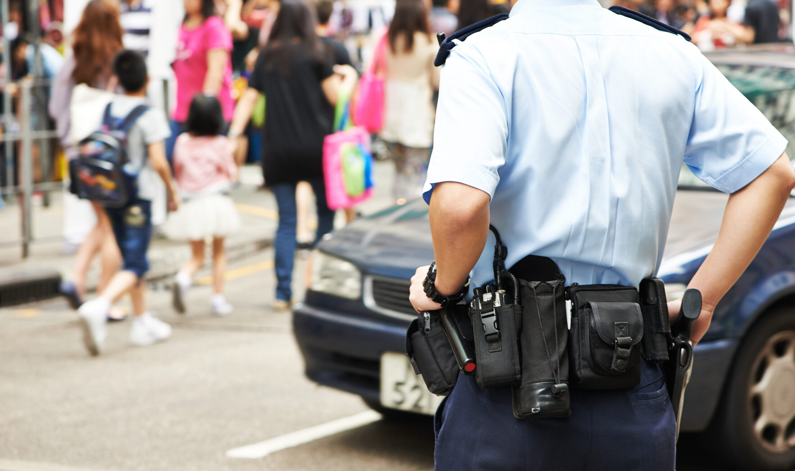 City,Security.,Policeman,Watching,Order,In,The,Urban,Street