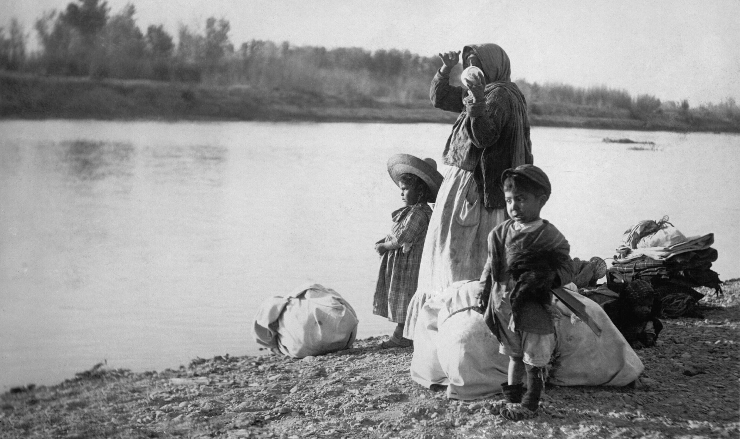 Mexican,Women,With,Her,Children,And,Bundles,On,The,Edge