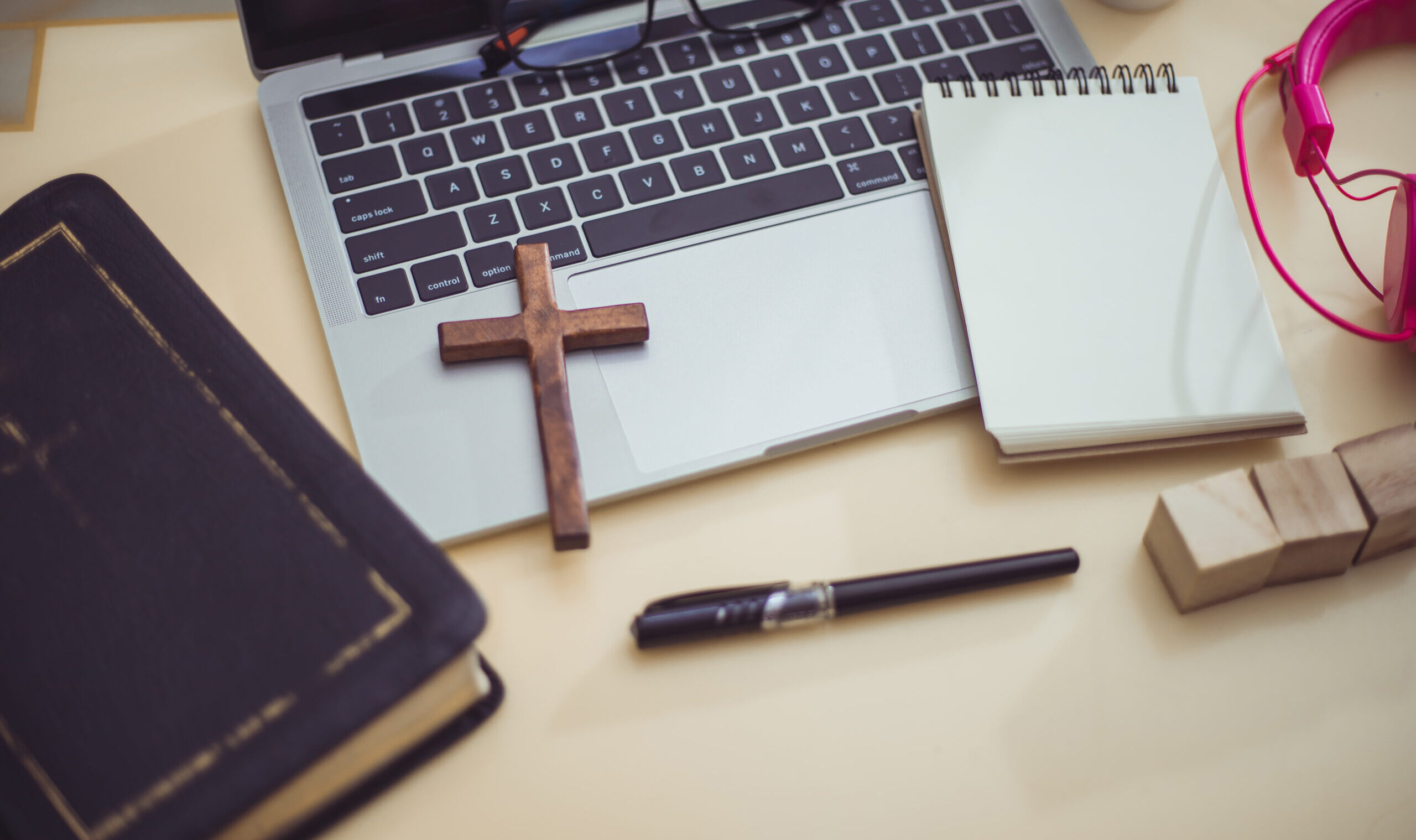 Cross,On,Bible,With,Headset,And,Laptop,In,Online,Study