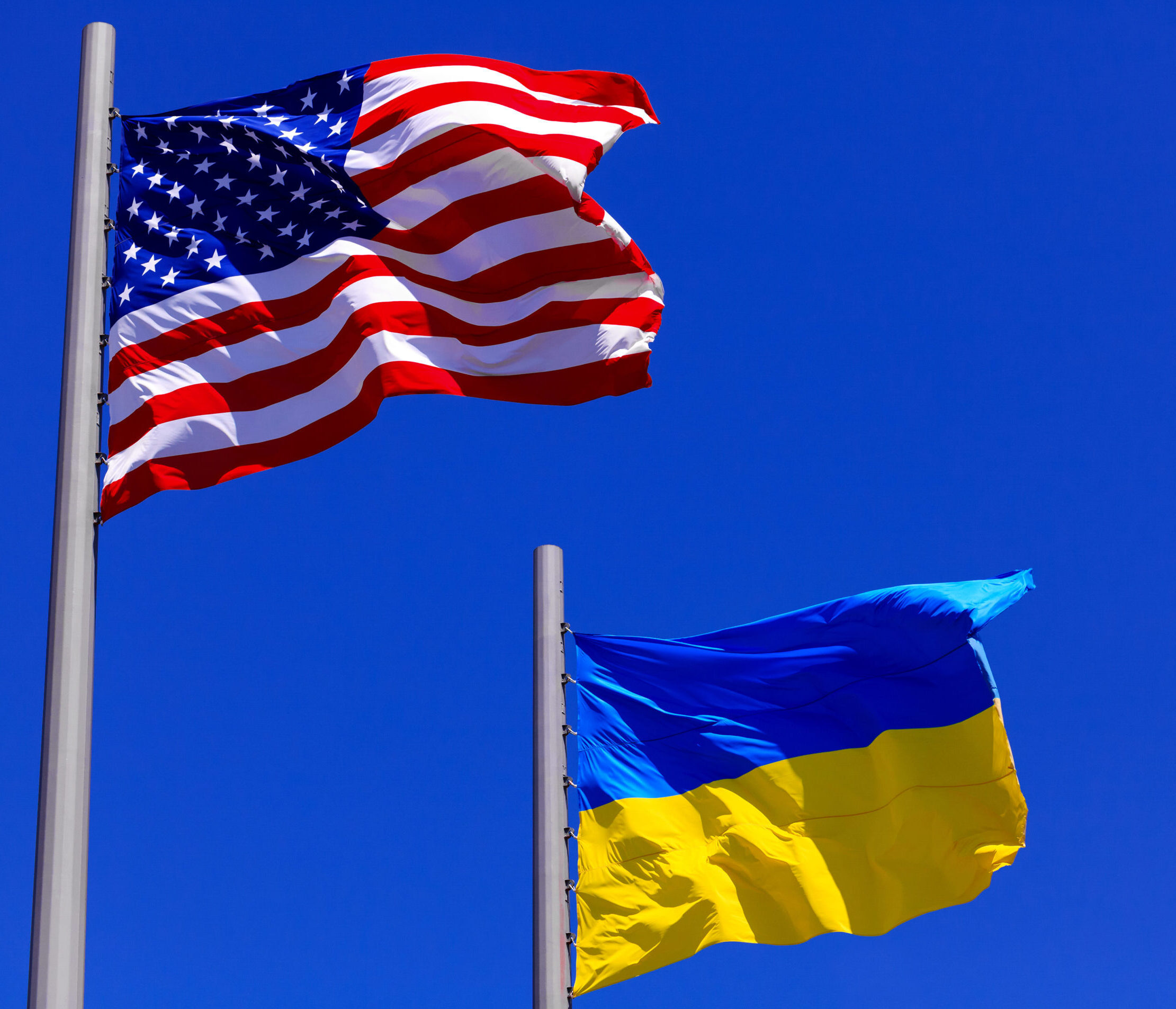 Flags,Of,The,Usa,And,Ukraine,Against,Bright,Blue,Sky