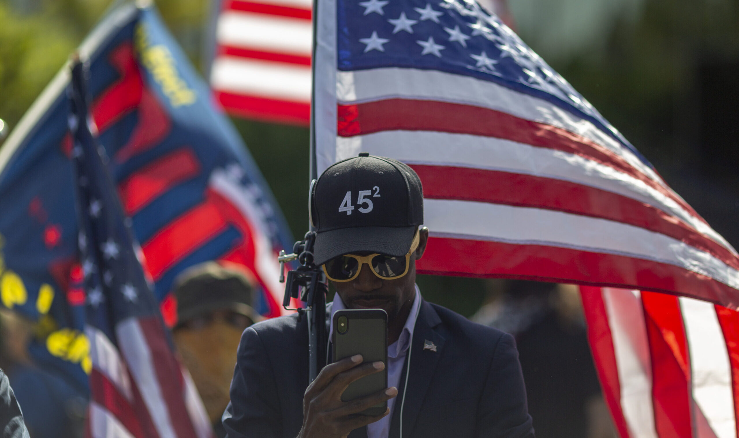 Trump Supporter with flag and hat