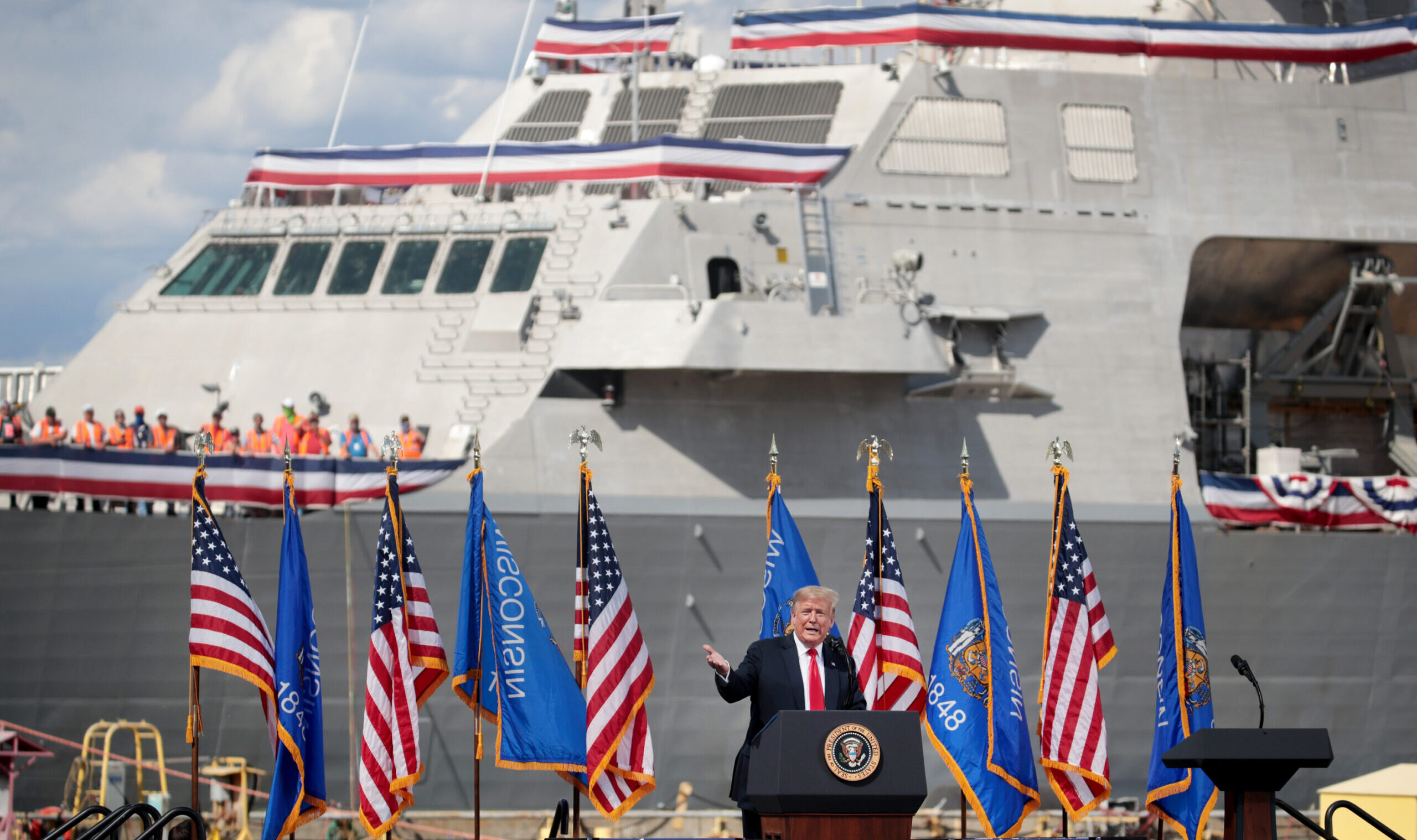 Trump in front of naval vessel