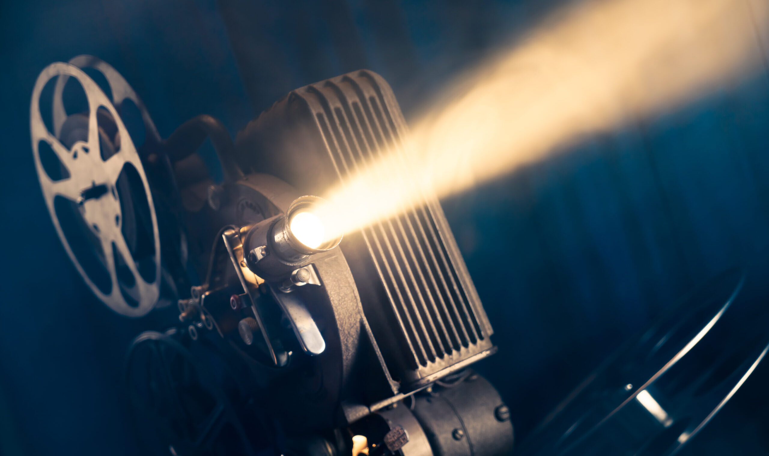 Film,Projector,On,A,Wooden,Background,With,Dramatic,Lighting,And